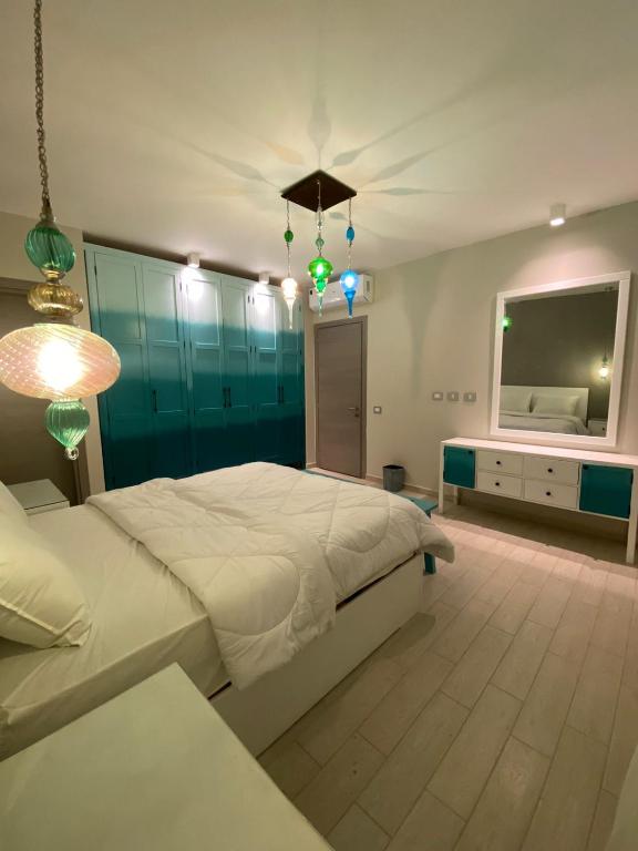 a bedroom with a bed and a flat screen tv at Luxury Chalet Il Monte Galala in Ain Sokhna