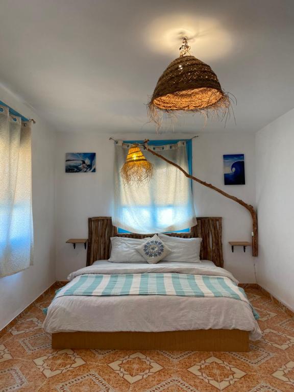 a bedroom with a large bed with a canopy at Sunny Soul Taghazout in Taghazout