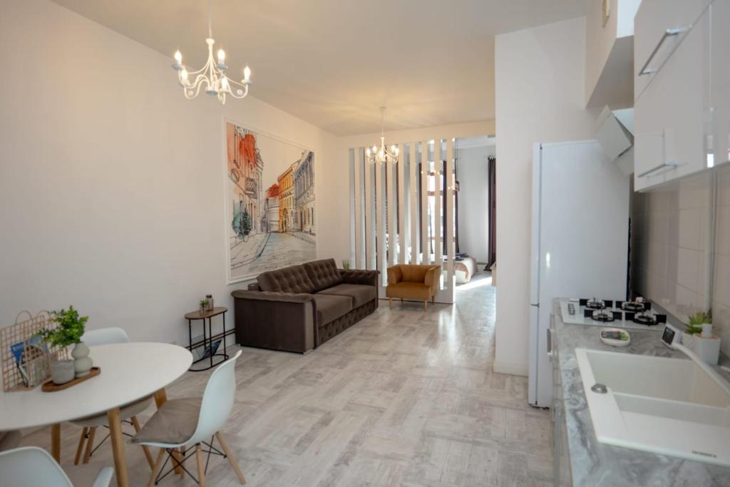 a living room with a couch and a table at Vintage Apartament Turda in Turda