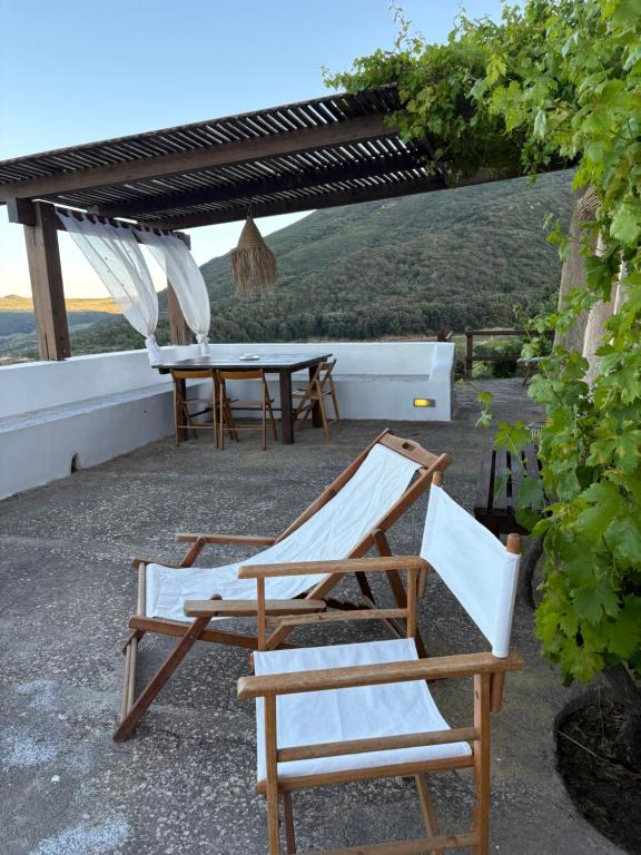 a couple of chairs and a table on a patio at Dammuso del Nonno in Pantelleria