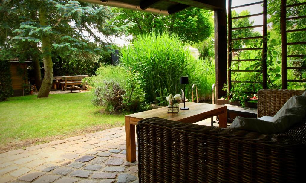 an outdoor patio with a wooden table and chairs at Apartment in Berlin-Köpenick in Berlin