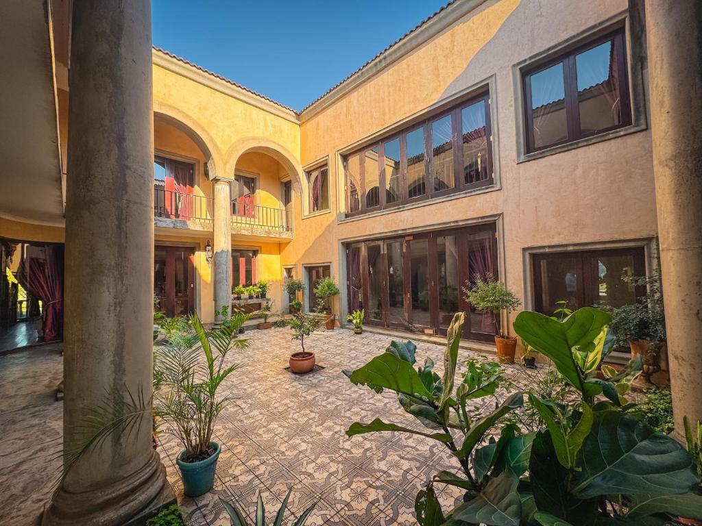 a courtyard with potted plants in a building at Vaal-Villa, Vintage Style Farmhouse, Vaal River in Vanderbijlpark