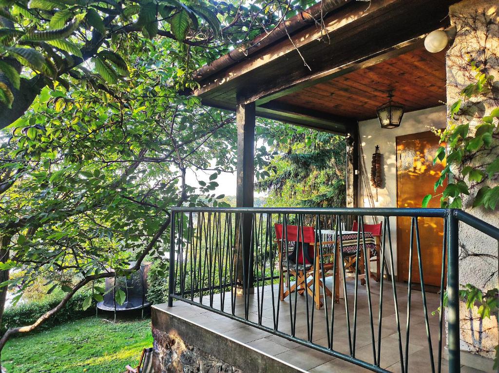 a balcony of a house with a table and chairs at Bocke Beach House in Novi Sad