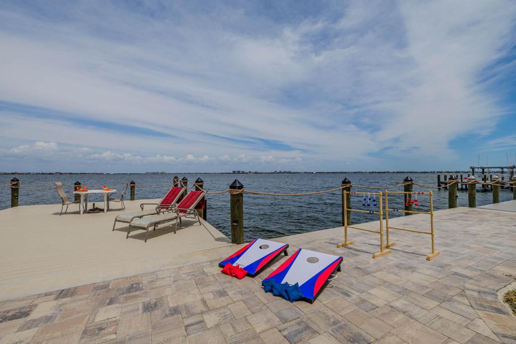 a dock with chairs and a table on the water at SeaBreeze Vista in Cape Coral