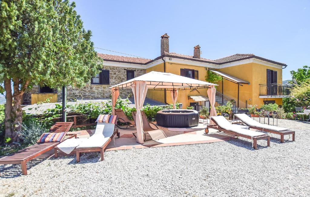 a gazebo with chairs and an umbrella in a yard at Pet Friendly Home In Laureana Cilento in Laureana Cilento