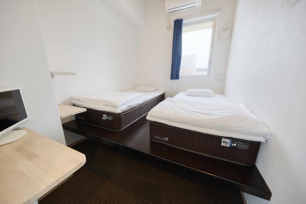 Postel nebo postele na pokoji v ubytování Chura Cabin Kokusai-Dori