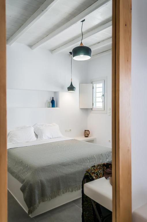Postel nebo postele na pokoji v ubytování Vilos Suites