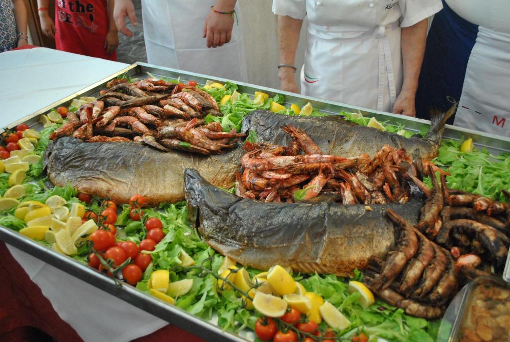 a tray of food with seafood and vegetables on a table at Hotel Maxim in Caorle