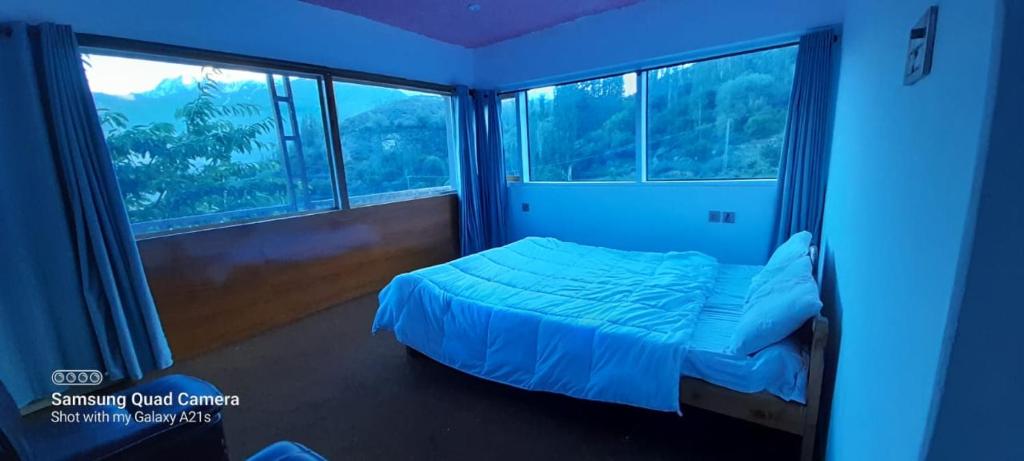 a bedroom with a bed and a large window at DIAMOND Hotel and Resort in Dargai