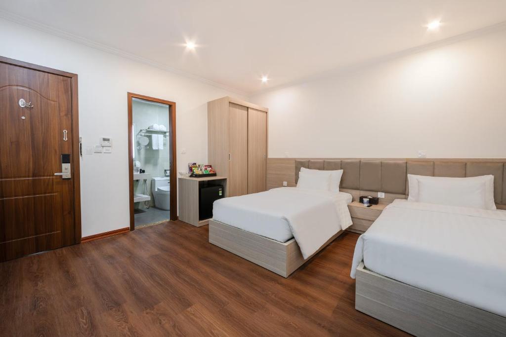 Postel nebo postele na pokoji v ubytování A25 Hotel - Hoàng Đạo Thúy 2