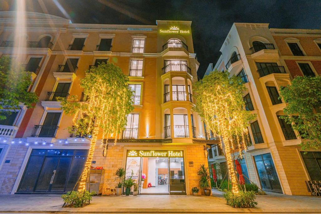 a building with christmas lights in front of it at Sunflower Hotel in Sầm Sơn