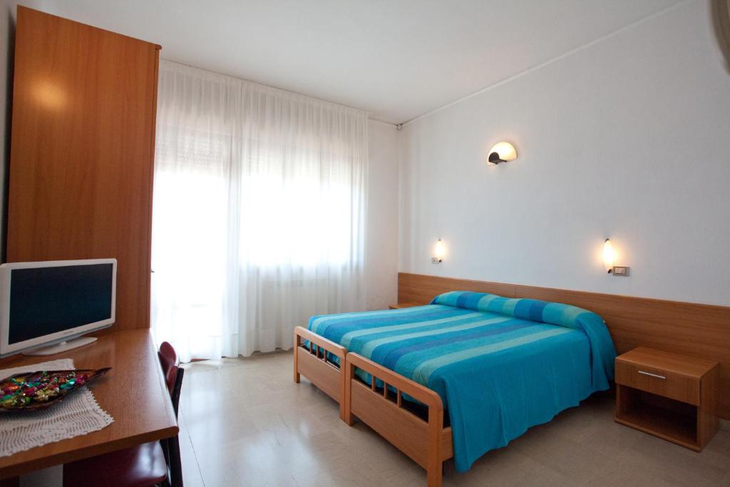 מיטה או מיטות בחדר ב-Hotel Caravel