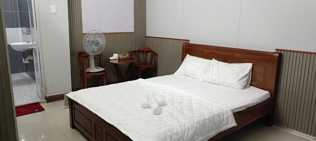 a bedroom with a bed with two candles on it at Motel ANA in Cái Răng