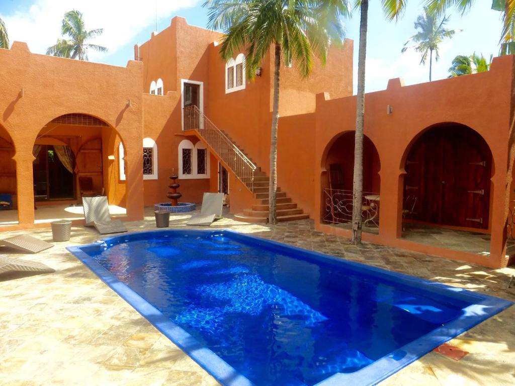 a swimming pool in front of a house at RIAD SAINT FRANCOIS & SPA in Rodrigues Island
