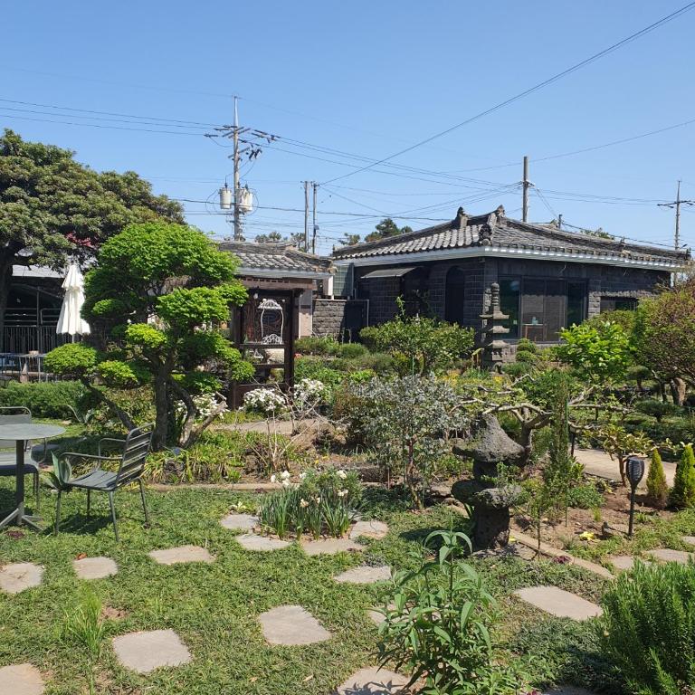 a garden in front of a house at Samojeong, Jeju in Jeju