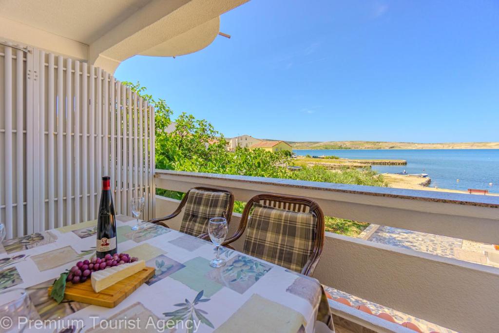 a table with a bottle of wine on a balcony at Rajka in Kustići