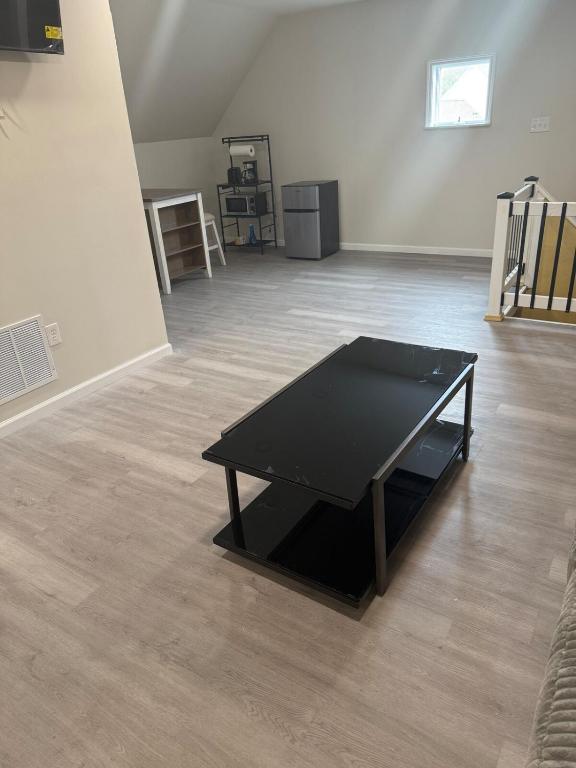 a black ping pong table in an empty room at Downtown Golden Stairs in Buffalo