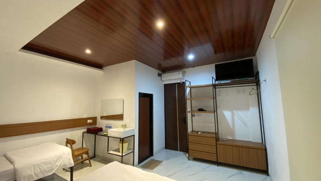 Postel nebo postele na pokoji v ubytování Batik Inn Semarang