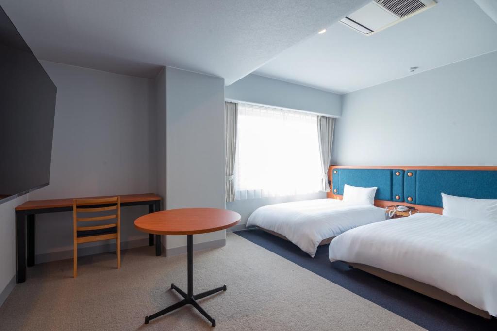 Postel nebo postele na pokoji v ubytování Hotel Global View Tsuchiura