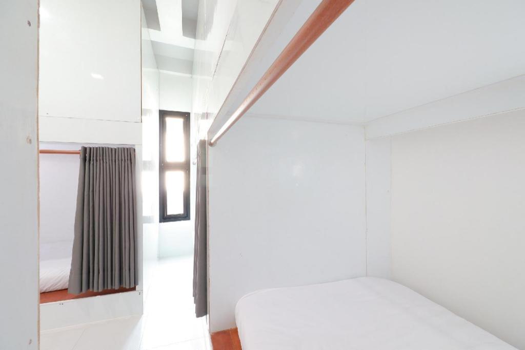 Postel nebo postele na pokoji v ubytování OYO 544 Sleep Sloth Hostel