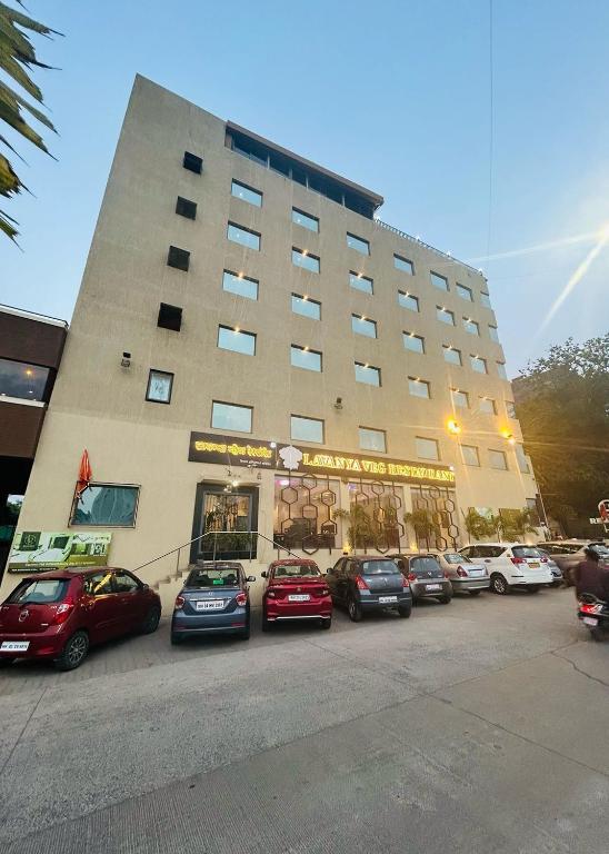 a large building with cars parked in front of it at LP Regency in Pune