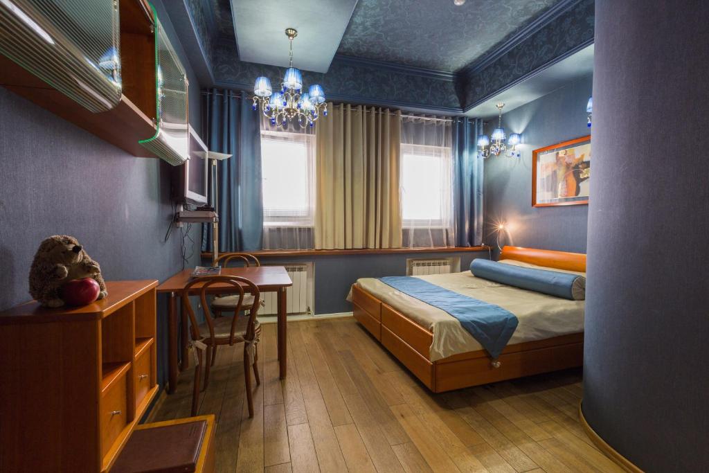 a bedroom with a bed and a desk and a table at The Volga House Boutique-Hotel in Kazan