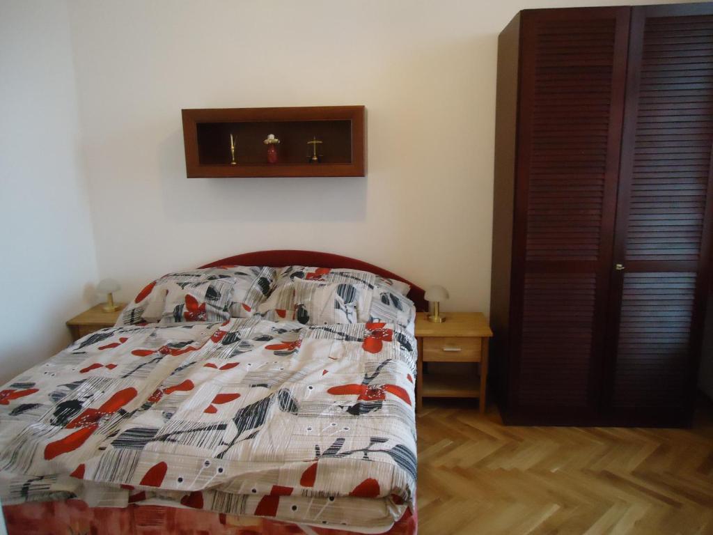 ein Bett mit einer Decke in einem Schlafzimmer in der Unterkunft Apartment Harmonia in Franzensbad