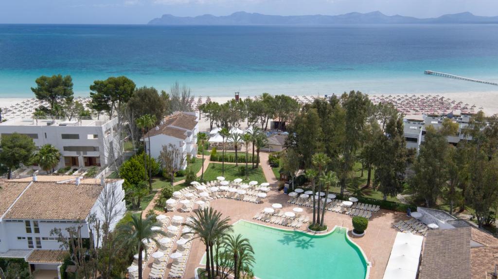 an aerial view of a resort with a swimming pool and the beach at Iberostar Ciudad Blanca in Port d'Alcudia