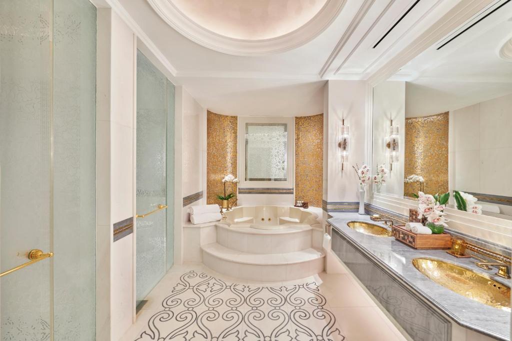 a bathroom with two sinks and a tub at Emirates Palace Mandarin Oriental, Abu Dhabi in Abu Dhabi