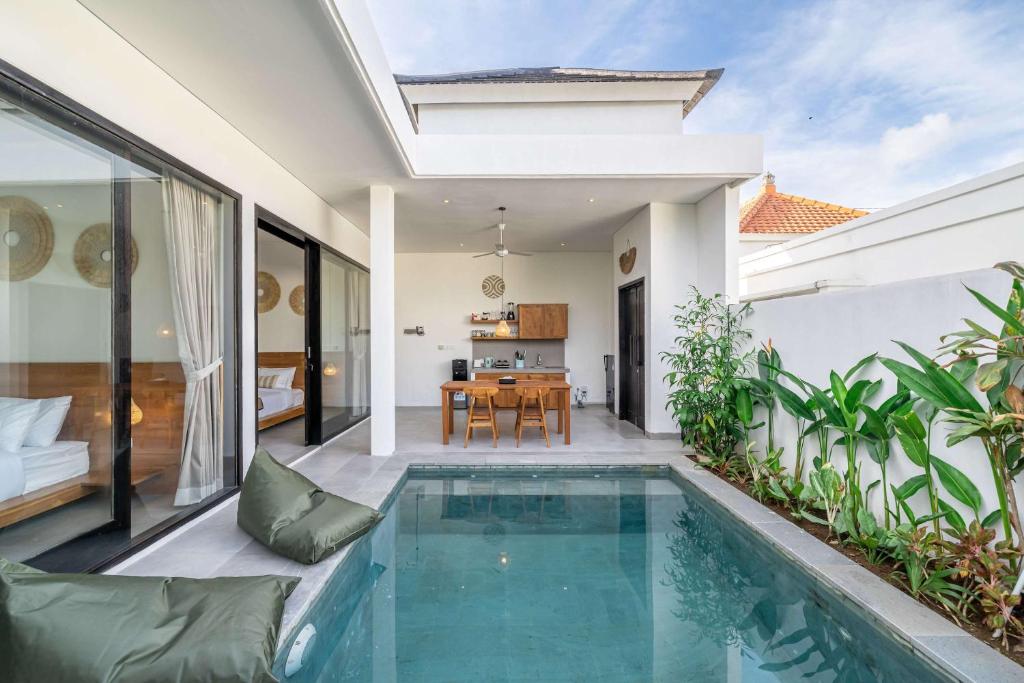 a villa with a swimming pool and a dining room at Peaceful 2BR Pool Villa in Kerobokan - V2 in Kerobokan