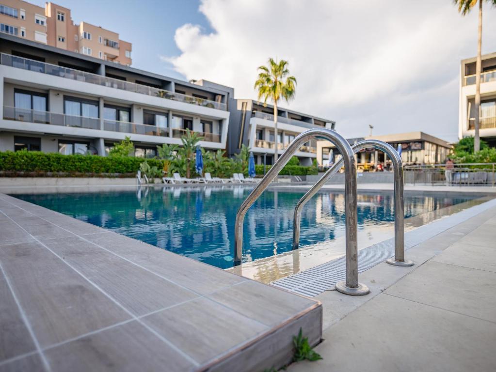 a swimming pool in front of a building at KS Habithouse GLORY LIFE LARA in ANTALYA in Antalya