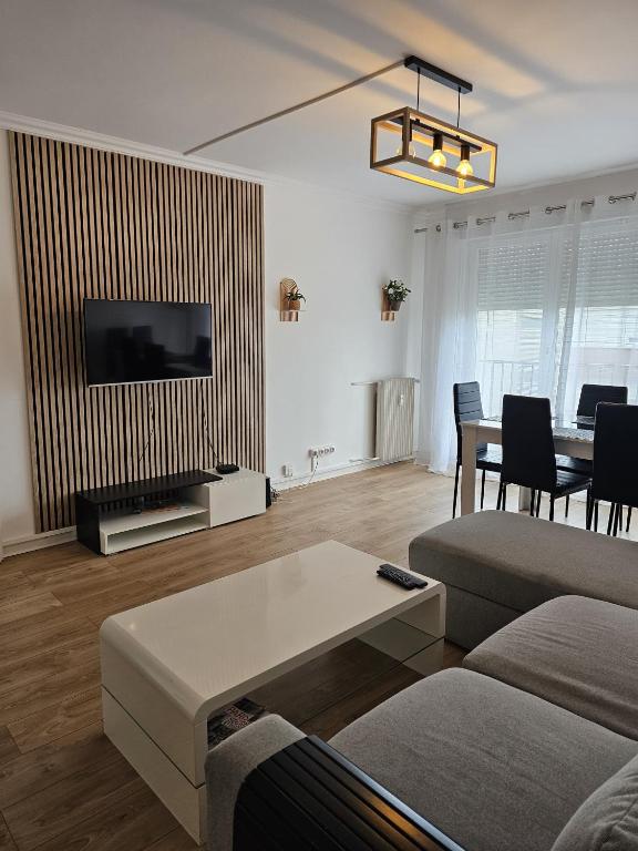 un salon avec un canapé et une table dans l'établissement Élégant 3 pièces proche Paris La Défense, à Bezons