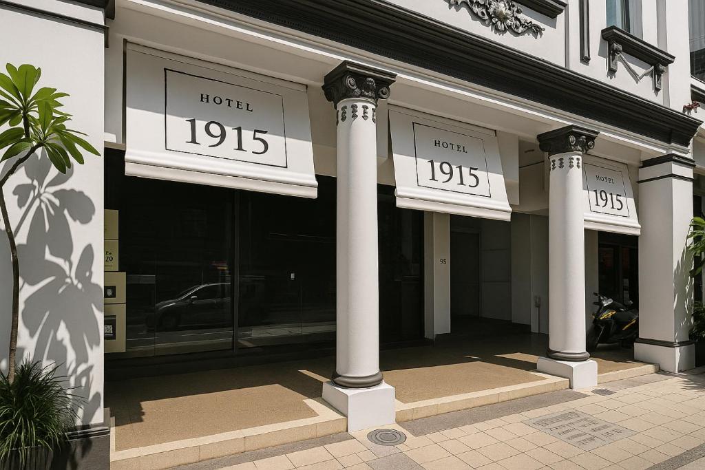 a building with two clocks on the front of it at Hotel 1915 Chinatown Kuala Lumpur in Kuala Lumpur