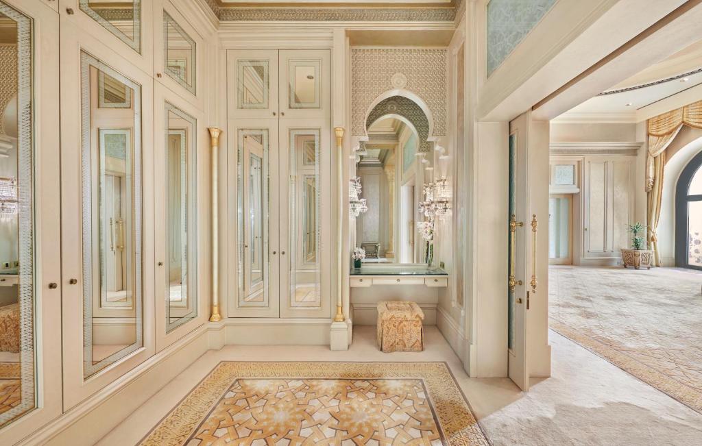 a large room with a vanity and a mirror at Emirates Palace Mandarin Oriental, Abu Dhabi in Abu Dhabi