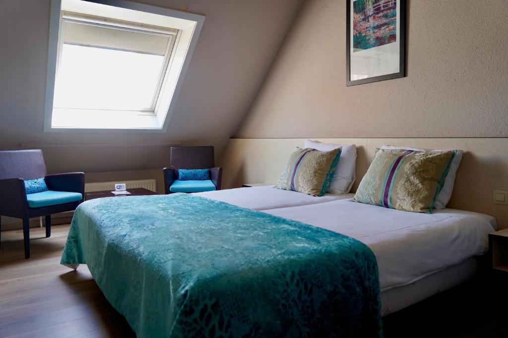 Postel nebo postele na pokoji v ubytování Hotel Prins Boudewijn