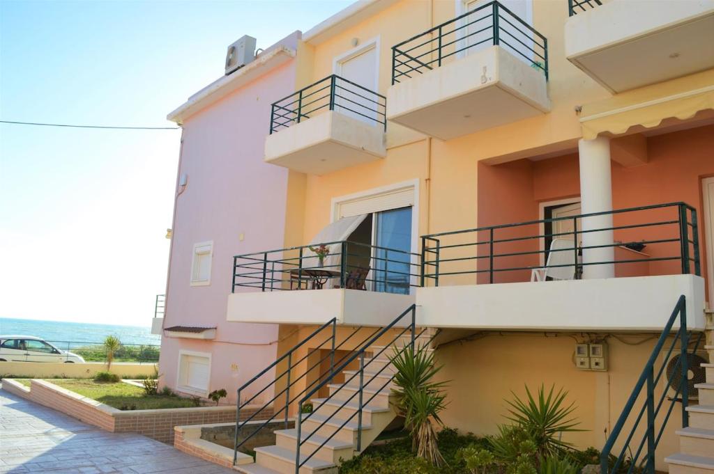 a building with stairs and balconies on it at Effie's Vacation House in Kanali