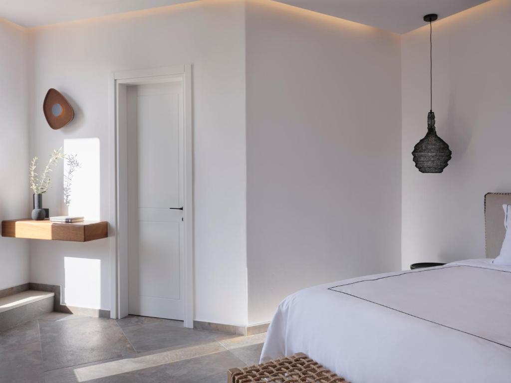 Postel nebo postele na pokoji v ubytování Kalea Mykonos