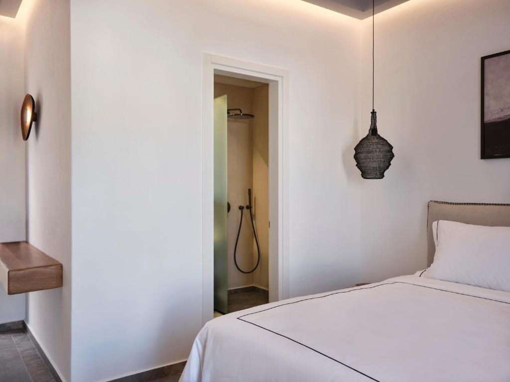 Postel nebo postele na pokoji v ubytování Kalea Mykonos