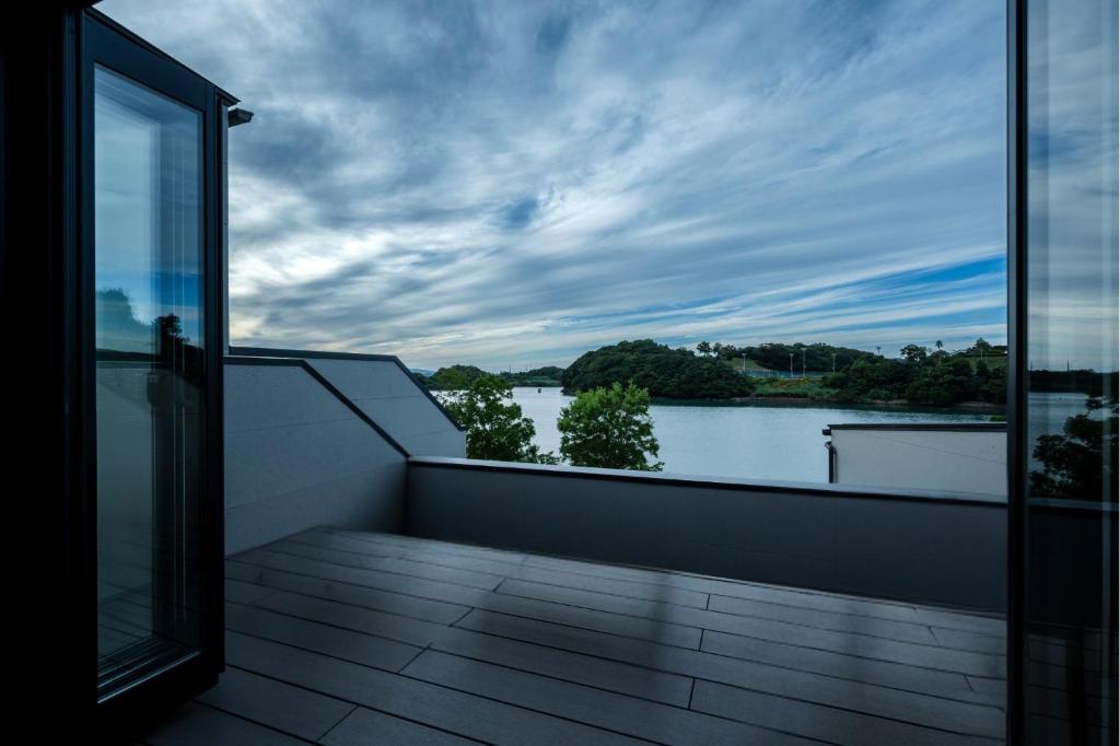 a balcony with a view of a body of water at Seaside Villa N - Vacation STAY 21991v in Mitsugoe