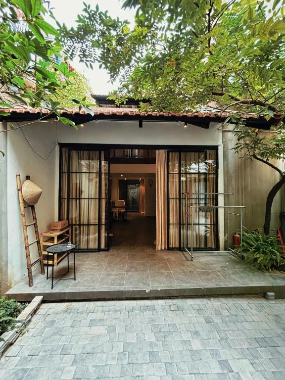 a house with a patio with a table and a chair at Ng house in Hanoi
