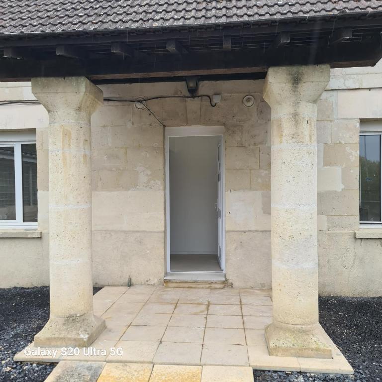 a door in a stone building with two columns at Maison typique picarde in Soissons