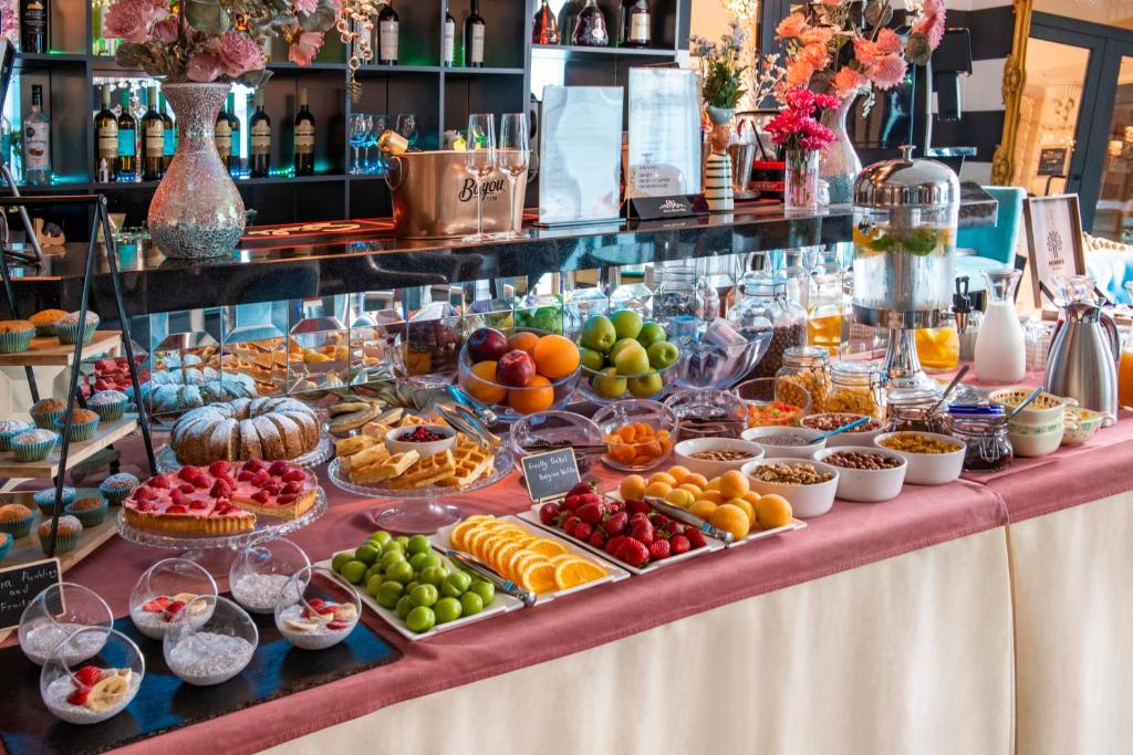 a buffet of fruit and vegetables on a table at River Side Hotel Tbilisi in Tbilisi City
