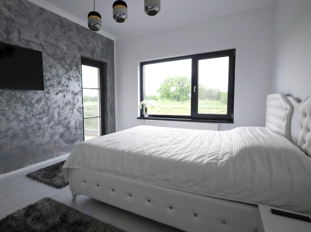 Postel nebo postele na pokoji v ubytování Grey House