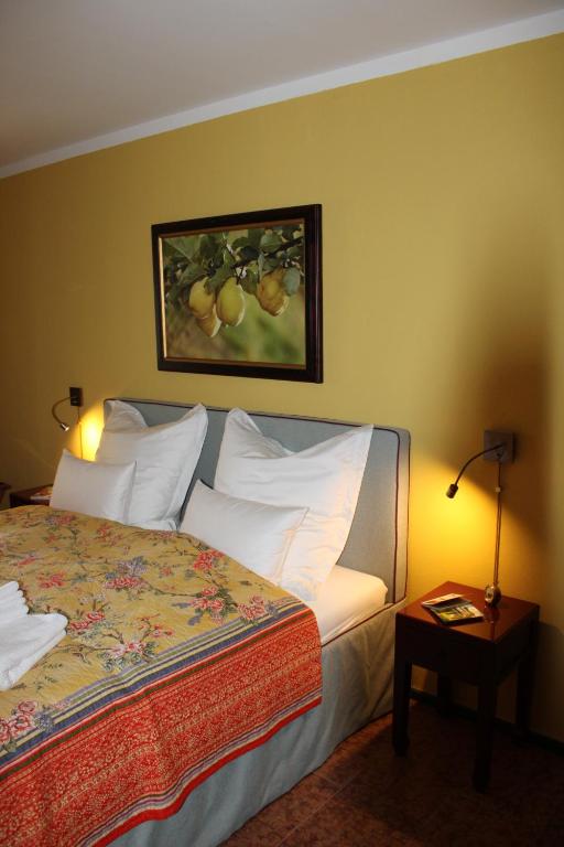 a bedroom with a bed with a picture on the wall at SEEBERGER GÜTL - by "Schloss Gessenberg" Exclusive apartments with a historic ambience for lovers of art and antiques in Petting