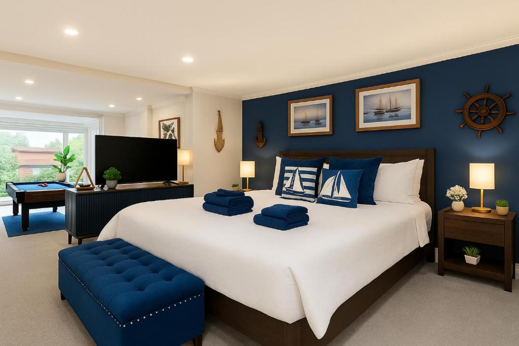 a bedroom with a large bed with blue walls at King Bed Harbour View - Captain's Retreat in Sydney