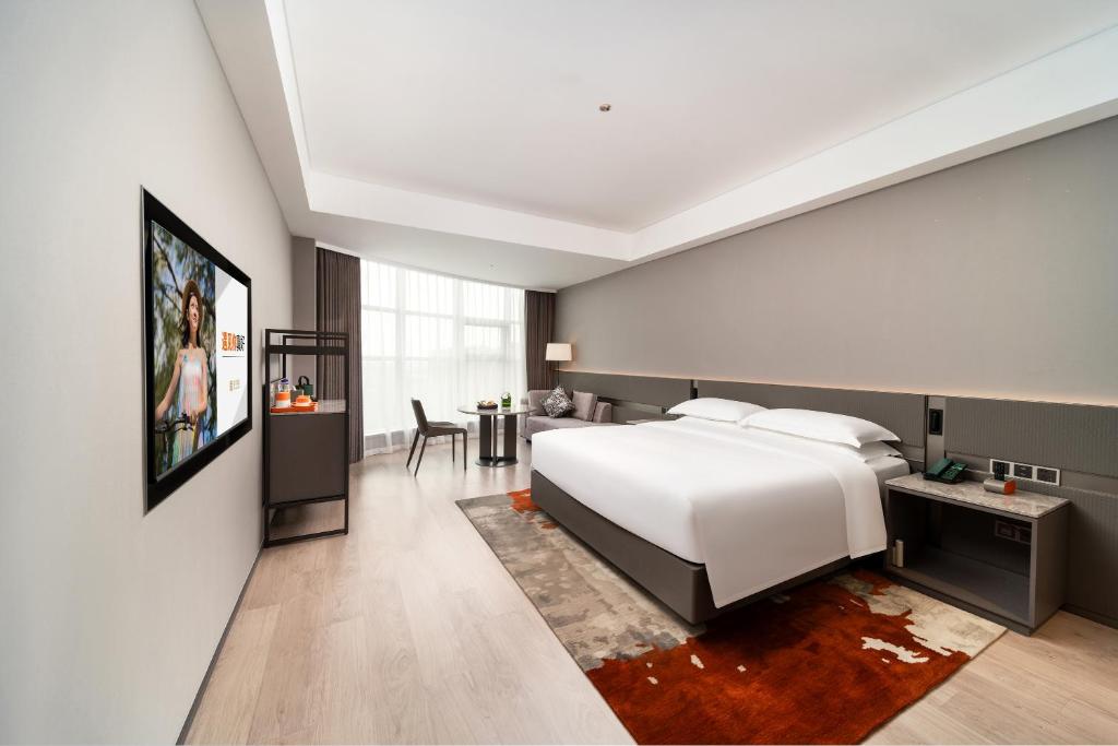 Postel nebo postele na pokoji v ubytování Ronghuitong SSAW Hotel