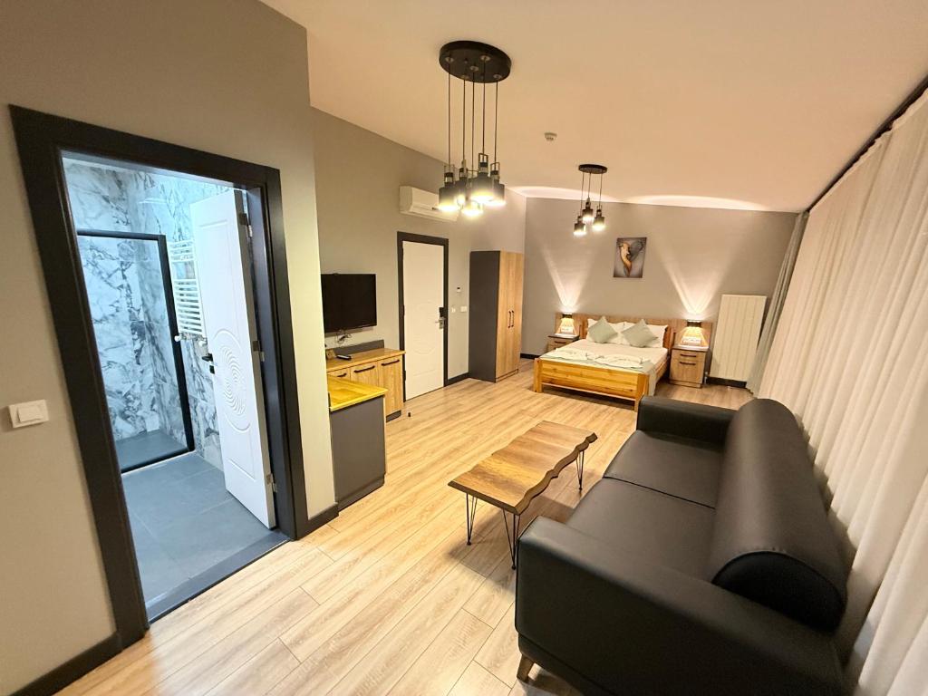 a living room with a couch and a bed at Taksim alkan tower residence in Istanbul