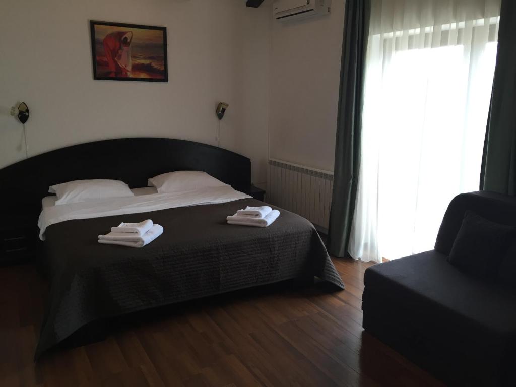ブラショヴにあるCasa Transilvaniaのベッドルーム1室(ベッド1台、タオル2枚付)
