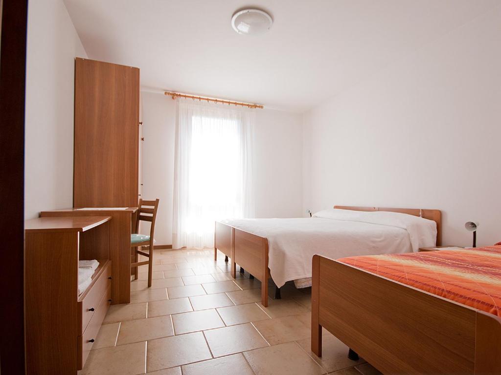 Postel nebo postele na pokoji v ubytování Albergo Alpino da Tullio