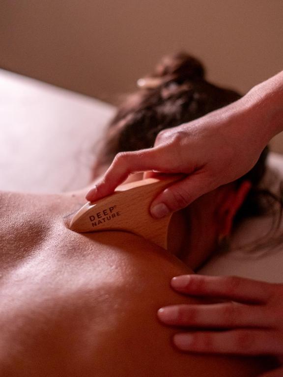 a man laying on a bed with a hair brush at Hôtel Villa M Marseille in Marseille